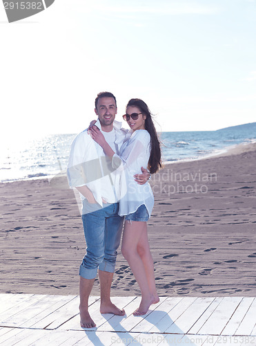 Image of young couple  on beach have fun