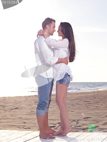 Image of young couple  on beach have fun