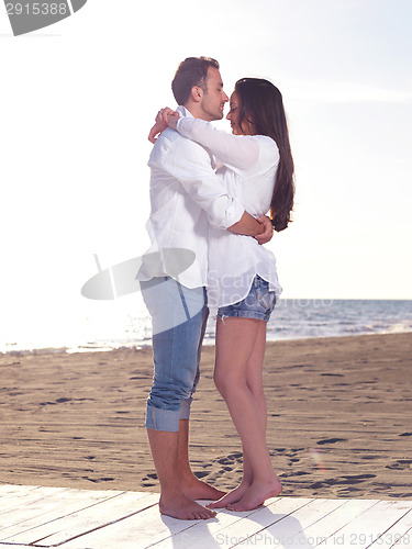 Image of young couple  on beach have fun