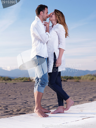 Image of young couple  on beach have fun