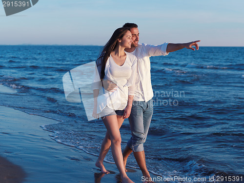 Image of young couple  on beach have fun