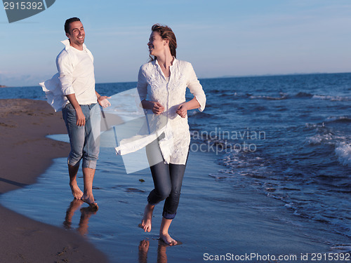 Image of young couple  on beach have fun