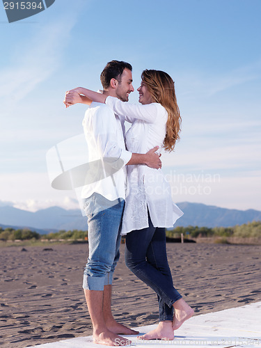 Image of young couple  on beach have fun