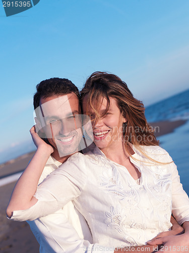 Image of young couple  on beach have fun