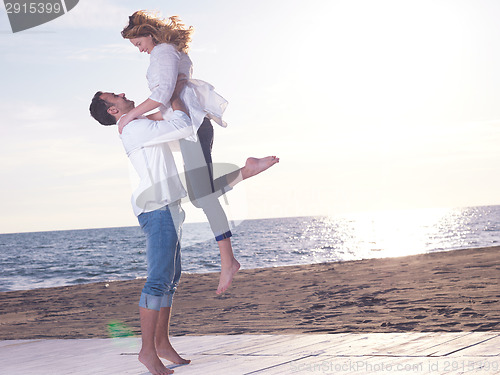 Image of young couple  on beach have fun