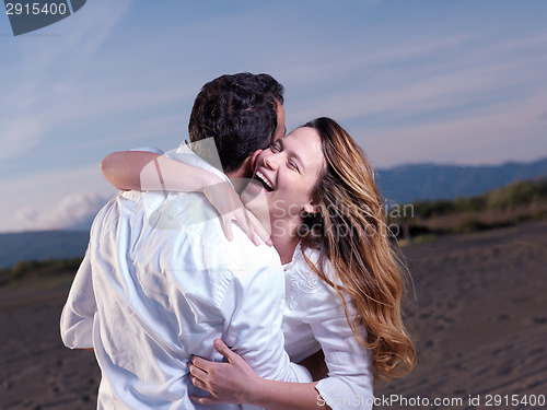 Image of young couple  on beach have fun