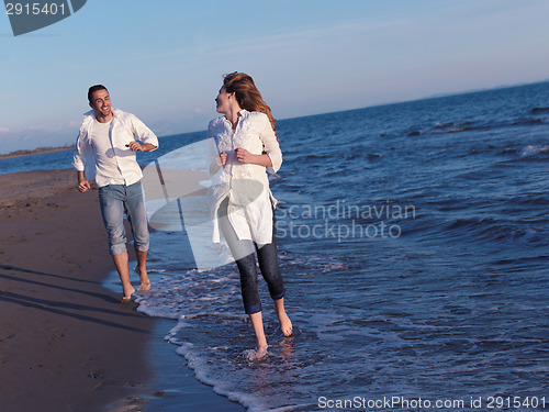 Image of young couple  on beach have fun