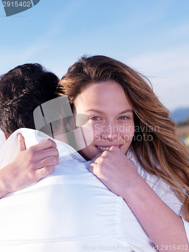 Image of young couple  on beach have fun