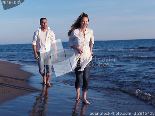 Image of young couple  on beach have fun