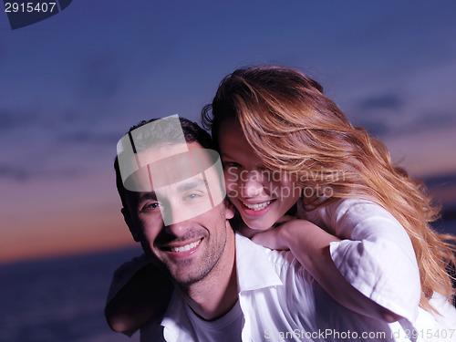 Image of young couple  on beach have fun