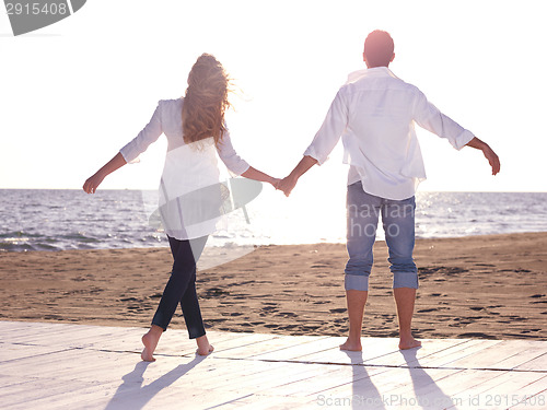 Image of young couple  on beach have fun