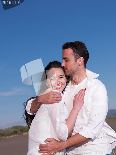 Image of young couple  on beach have fun
