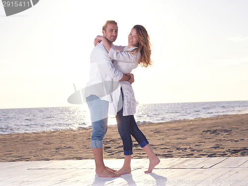 Image of young couple  on beach have fun