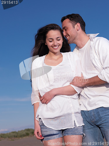 Image of young couple  on beach have fun