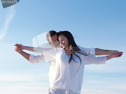 Image of young couple  on beach have fun