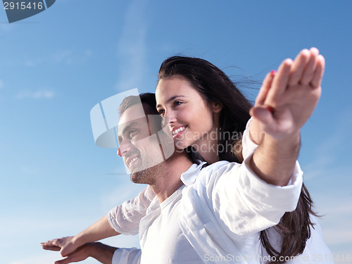 Image of young couple  on beach have fun