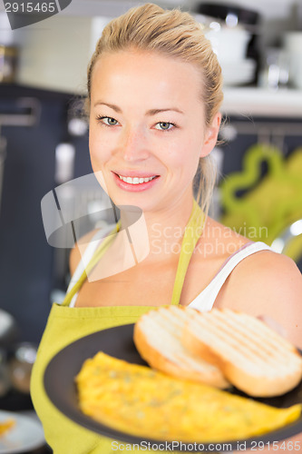 Image of Young Mother Cooking at Home.