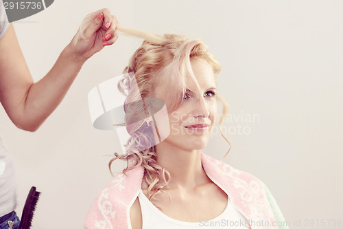 Image of hair stylist designer making hairstyle for woman