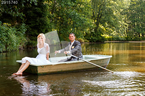 Image of Young just married bride and groom on boat