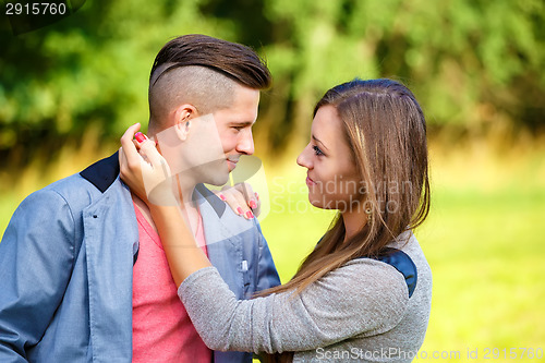 Image of Happy smiling young couple outdoor