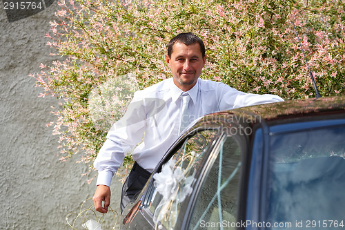 Image of groom preparing and decoration car in wedding day