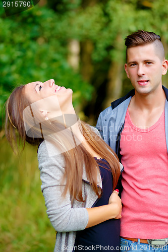 Image of Happy smiling young couple outdoor