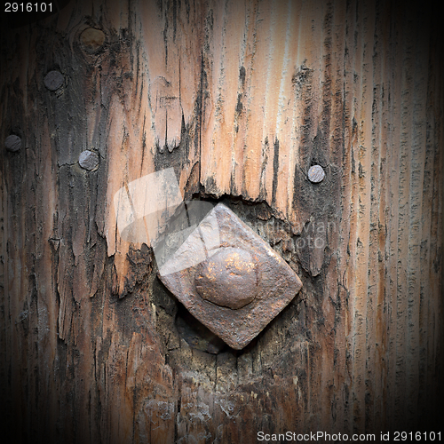 Image of old metallic nail in wood