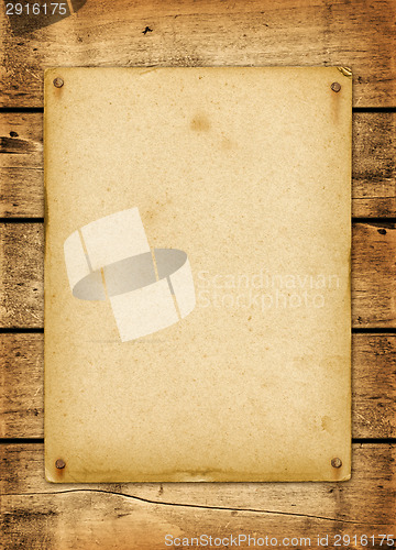 Image of Blank vintage poster nailed on a wood board