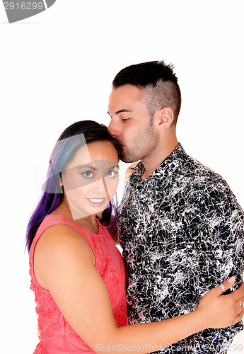 Image of Man kissing girl on head.