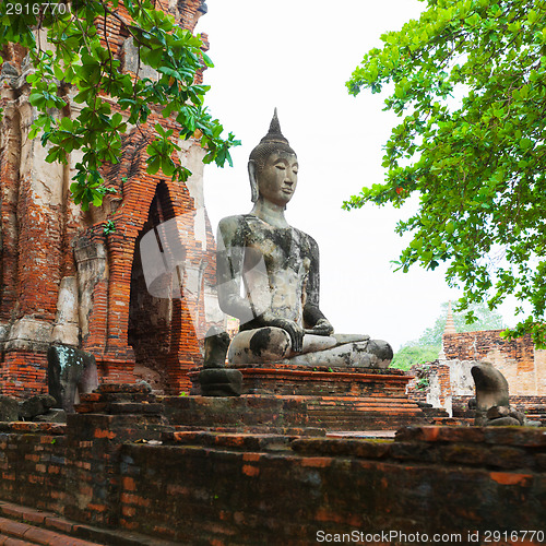 Image of Ancient stone statue of Buddha in ruins of a Buddhist temple. Th