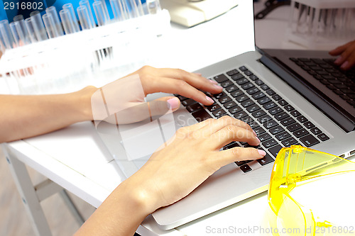 Image of Scientist hands on keyboard