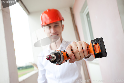 Image of smiling worker with drill