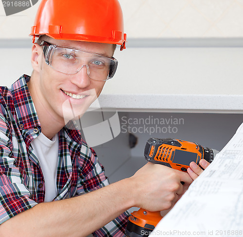 Image of worker with drill