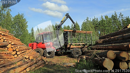 Image of Operator Stacking up Logs with Komatsu 830.3 Forestry Forwarder