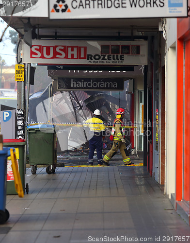 Image of Fire Search and Rescue begin searching the remains of a shop aft