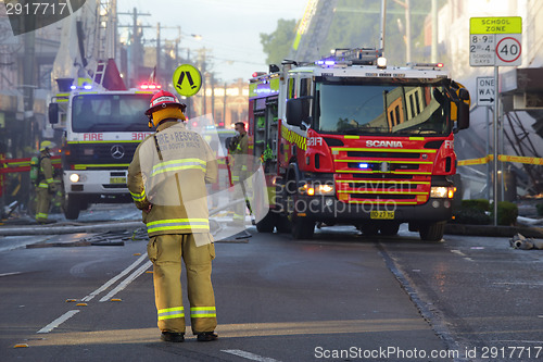 Image of Firefighters and rescue crew attend shop blast