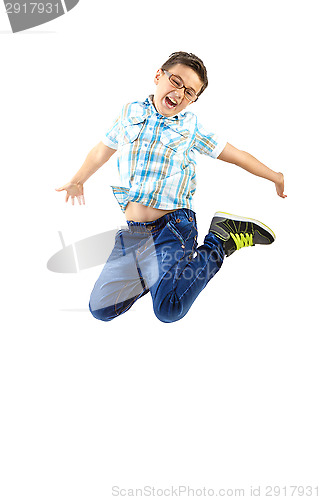 Image of happy little boy jumping on withe