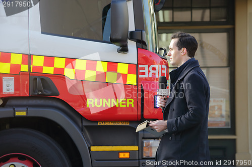 Image of News Reporter at scene covering tragic event