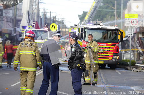 Image of Police and Fire fighters attend blast explosion at shop
