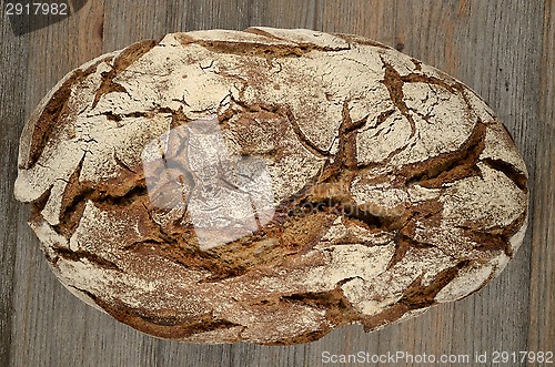 Image of a loaf of rye bread on wood 