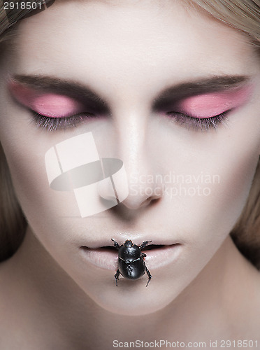 Image of Beauty portrait of model with make-up and bug on her lips