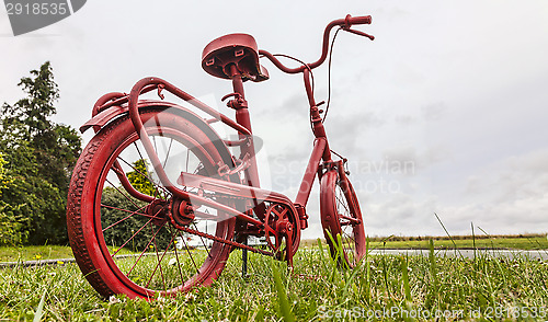 Image of Red Bicycle on the Roadside