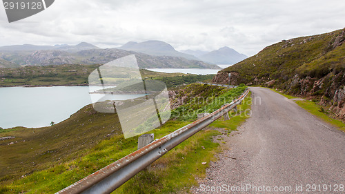 Image of Highlands of Scotland narrow road in mountain landscape