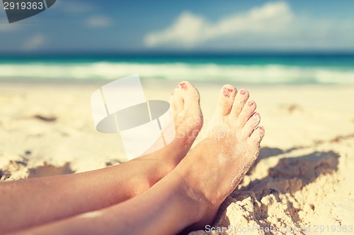 Image of closeup of woman legs on sea shore