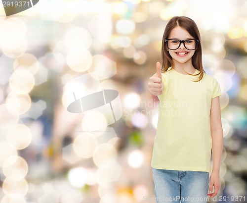 Image of smiling cute little girl in black eyeglasses