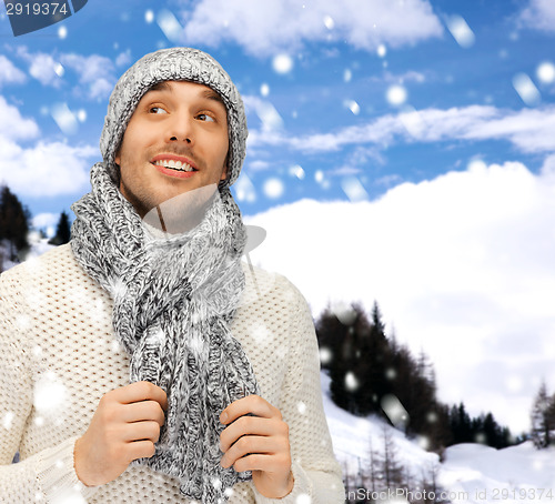 Image of handsome man in warm sweater, hat and scarf