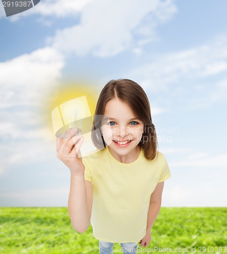 Image of smiling little girl holding light bulb