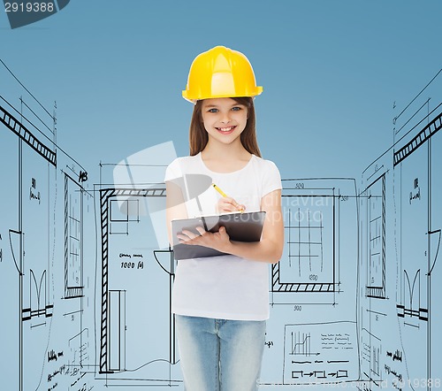 Image of smiling little girl in hardhat with clipboard