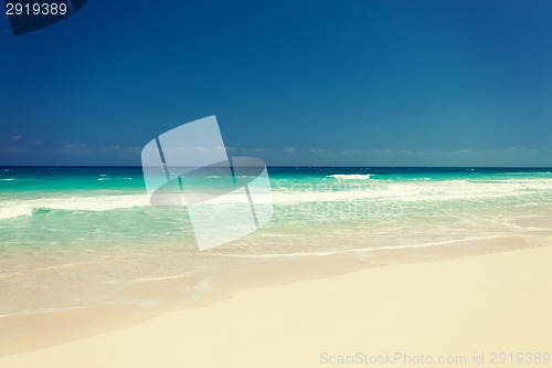 Image of blue sea or ocean, white sand and sky