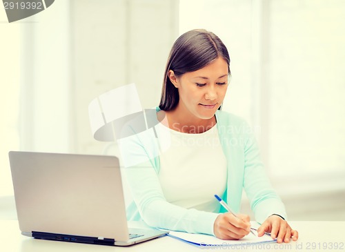 Image of asian businesswoman with laptop and documents